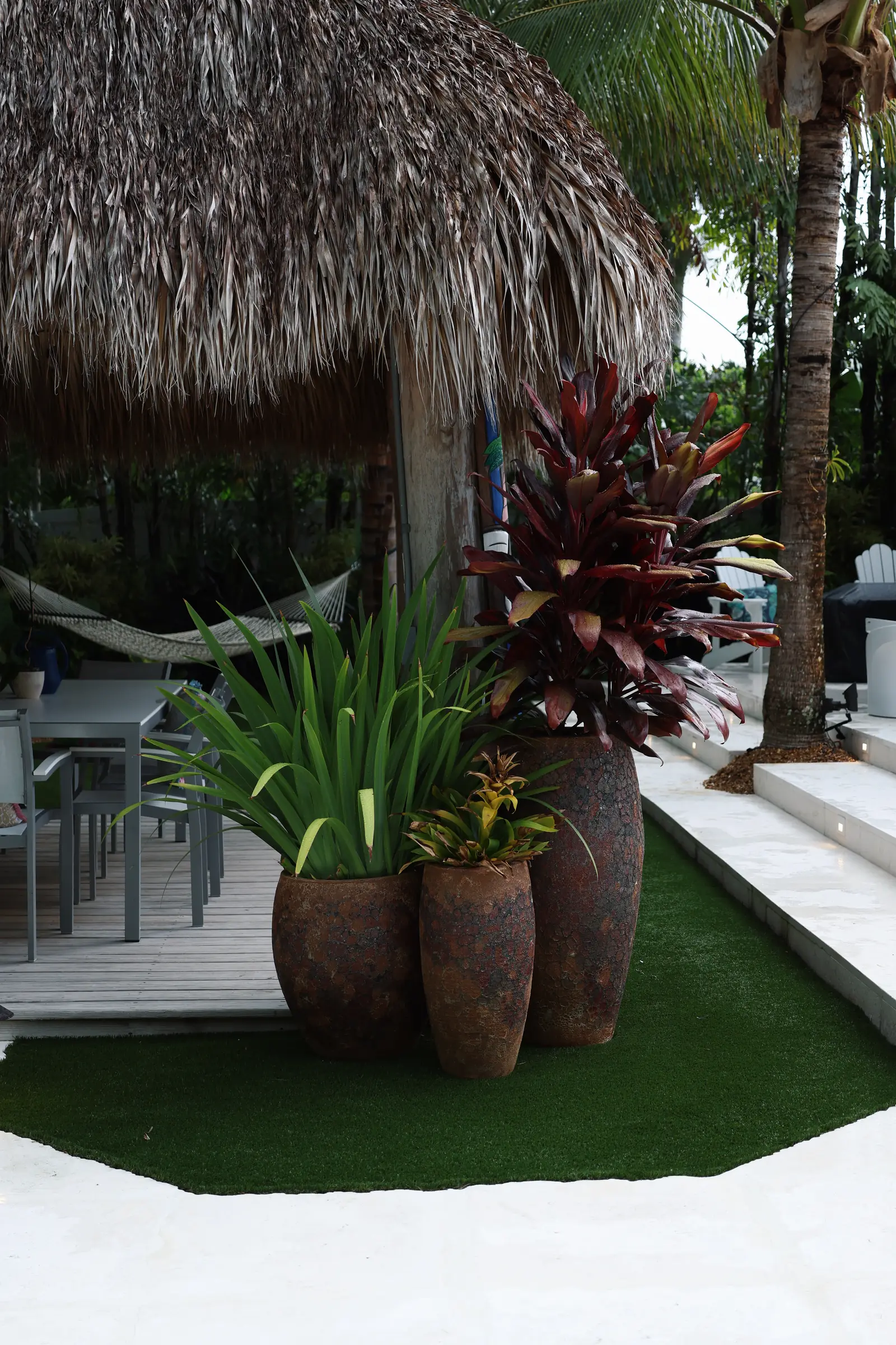 Rusted urn planters with agave and cordyline