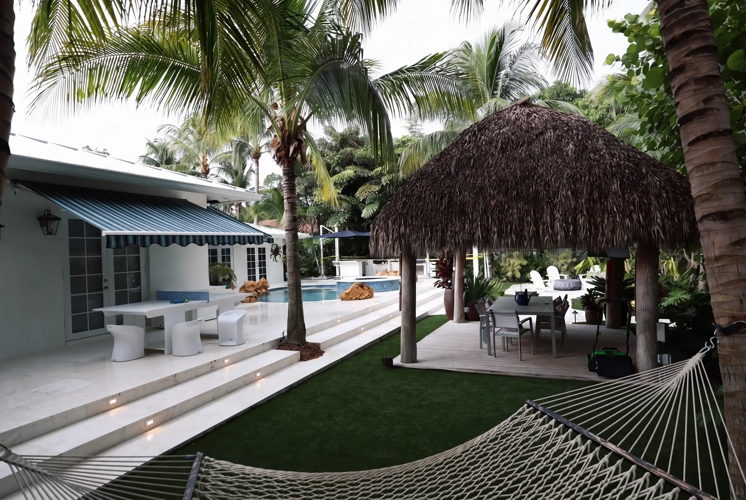 Tiki hut, pool and hammock foreground