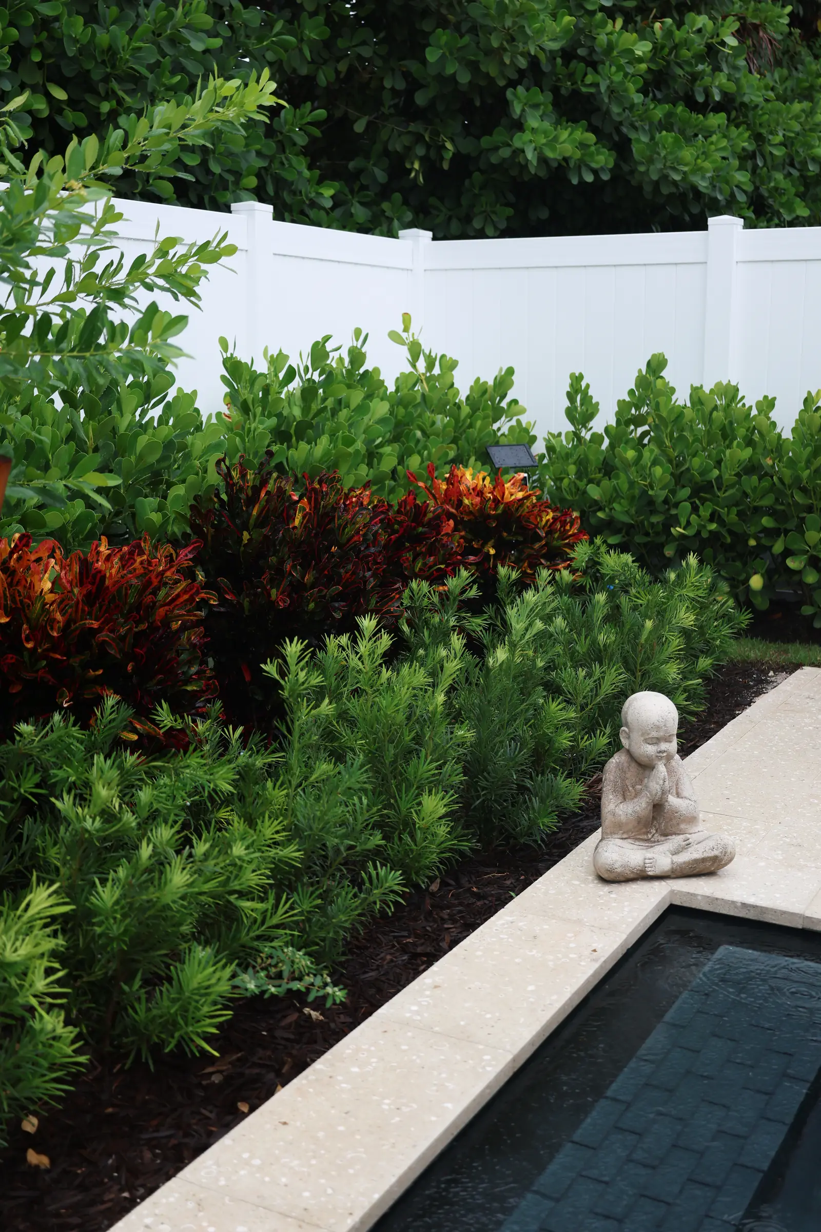 Buddha with red foliage, vertical