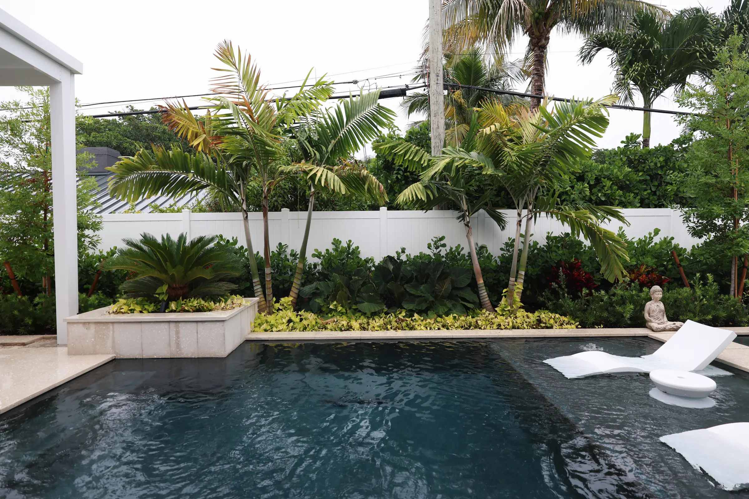 Dark pool, raised planter and palms