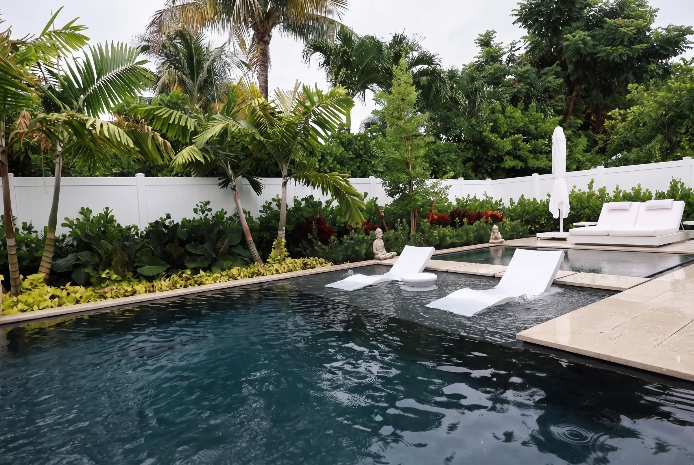 Dark pool with in-water loungers and buddha