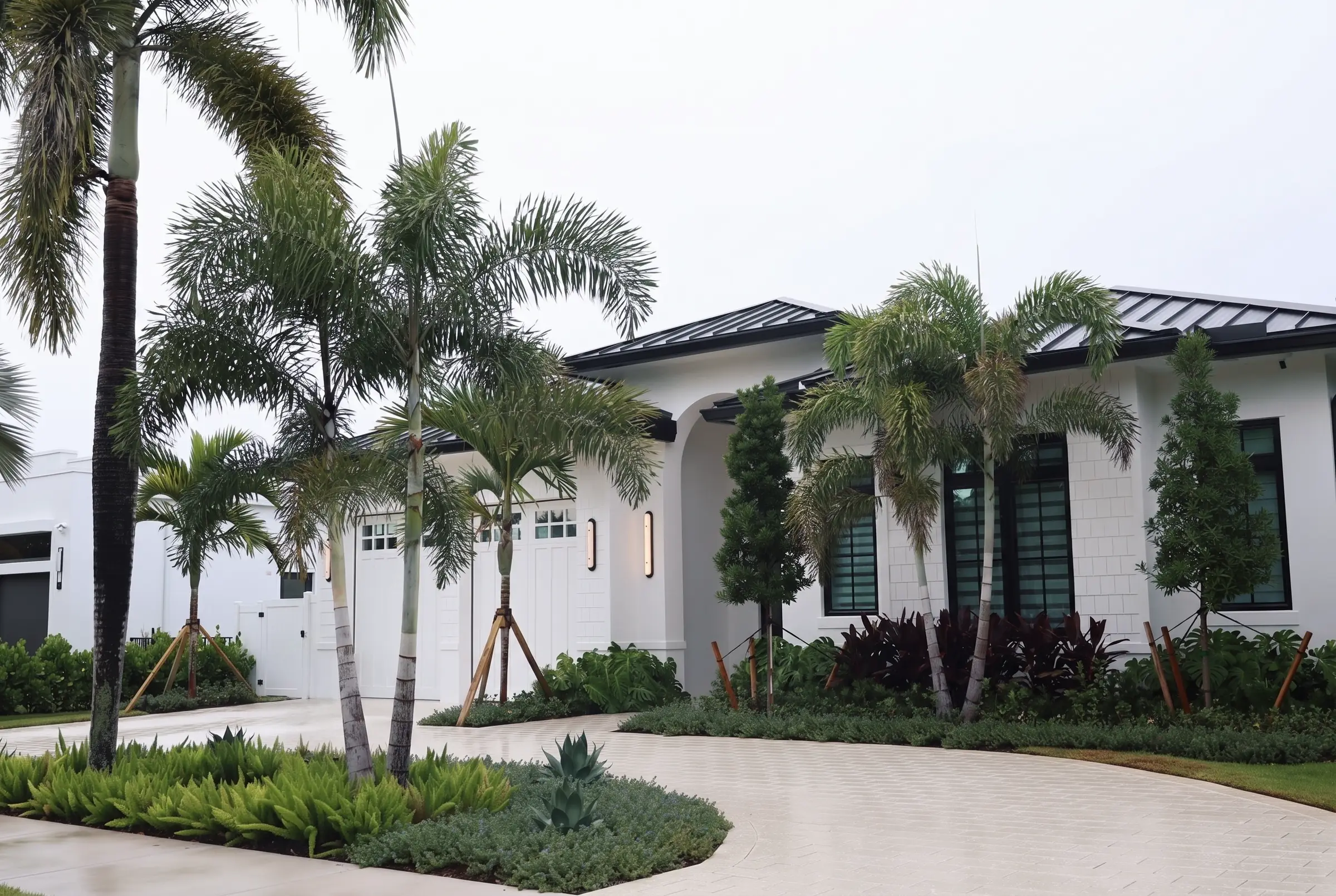 Curved paver drive and white facade