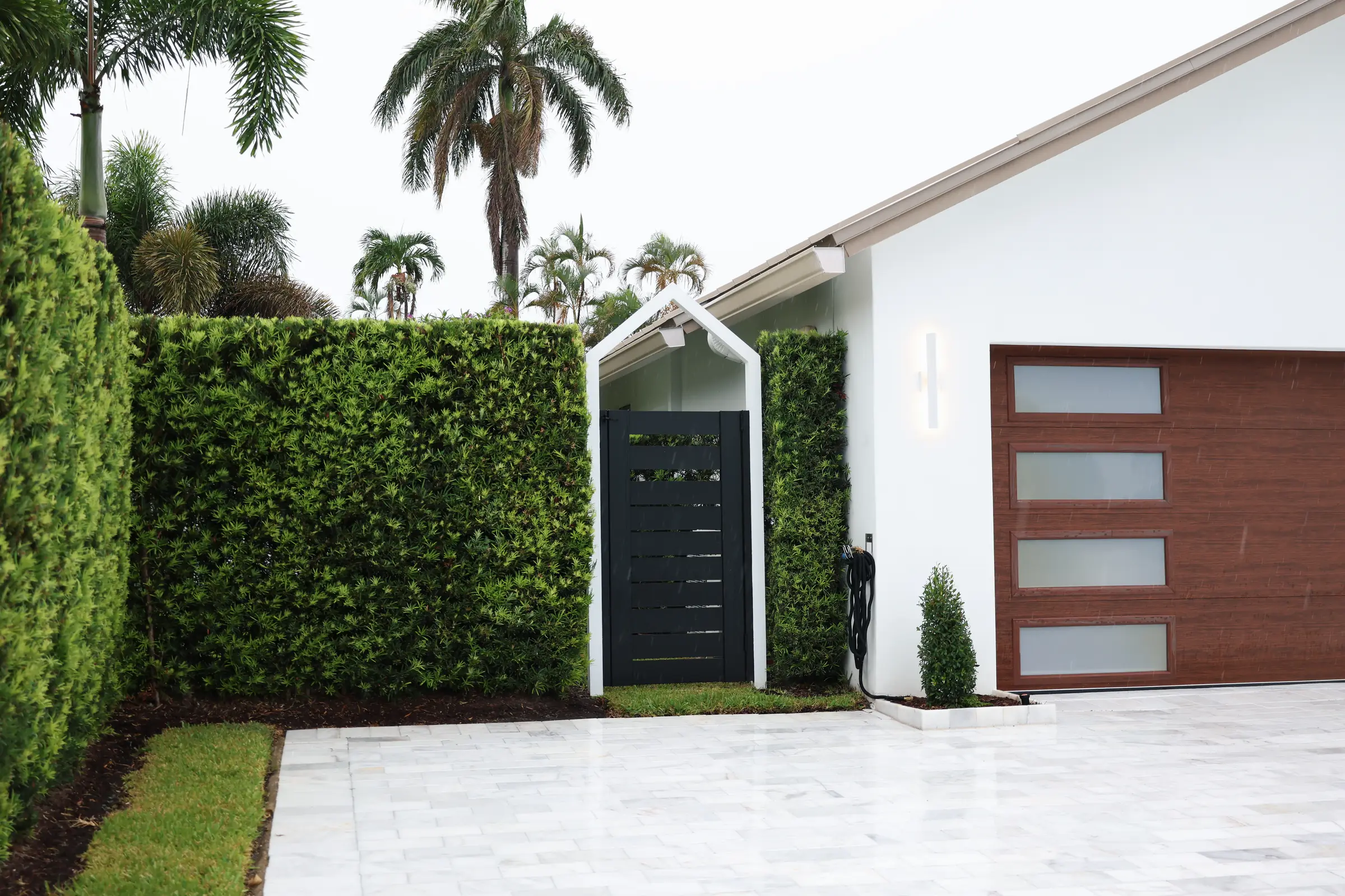 Entry door, hedge and garage